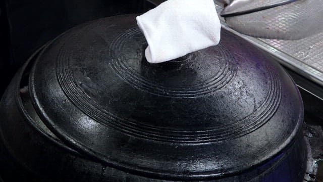 Cooking traditional cuisine in a large pot