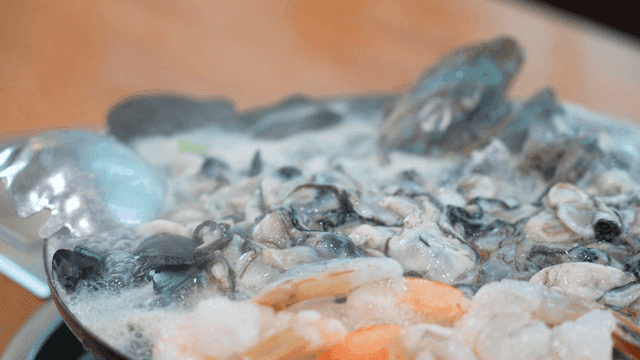 Oyster kalguksu boiling in pot