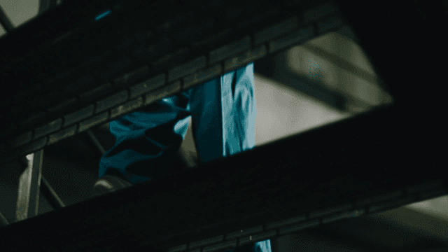 Prisoner coming down dark staircase