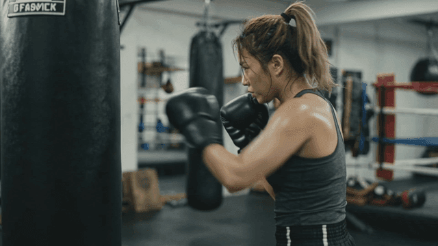Woman practicing boxing at gym