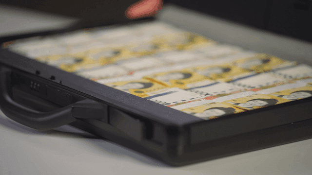 A briefcase filled with stacks of cash