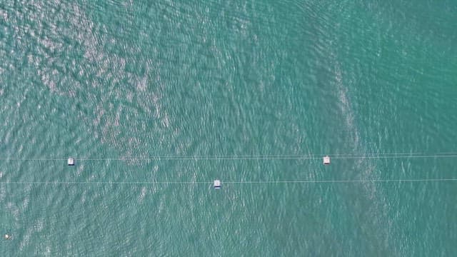 Cable cars and ships moving over the vast sea