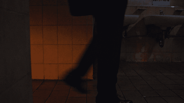 Man entering dark bathroom