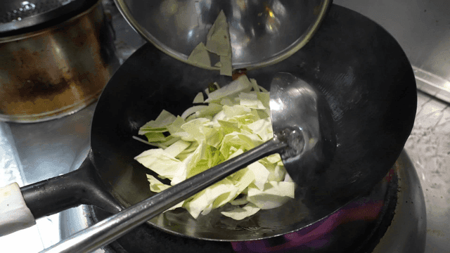 Cabbage poured from wok