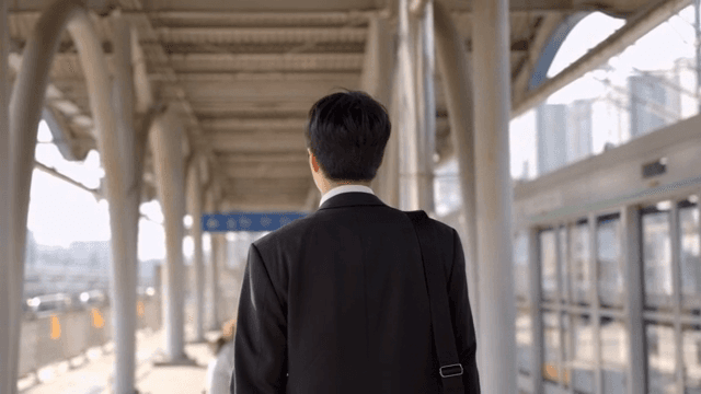 Office worker man walking on subway station platform
