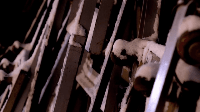 밤에 눈 덮인 금속 구조물