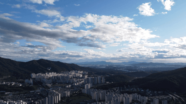 Cityscape with mountains and clouds
