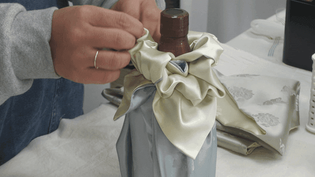 Wrapping a bottle with traditional fabric