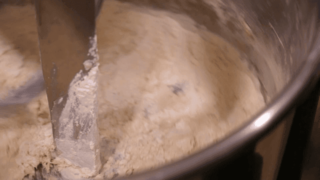 Dough being mixed in a large industrial mixer
