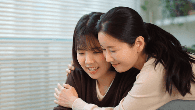 Mother and daughter hugging warmly at home