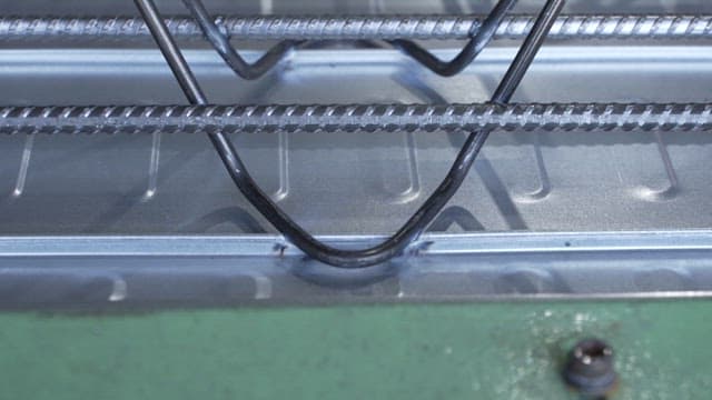 Close-up of metal rods being processed in a factory