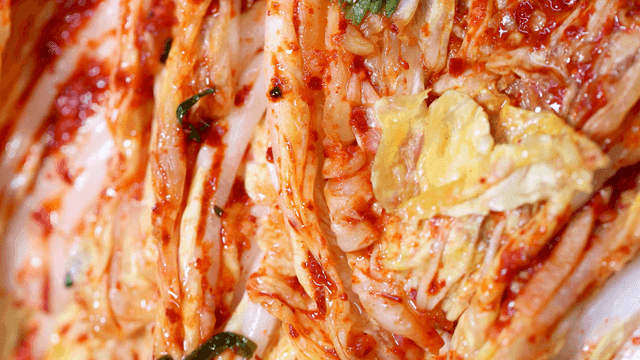 Fresh seasoned napa cabbage kimchi visible in detail