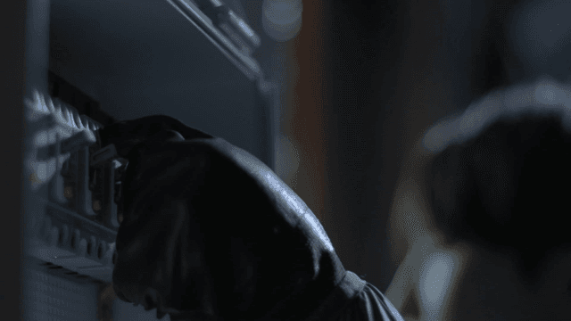 Person's hand turning switch on and off in dark power supply box