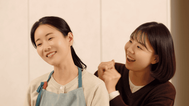 Daughter massaging mother's shoulders