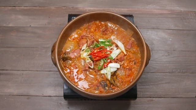 Kimchi stew with smoked duck, fresh chili peppers and green onions