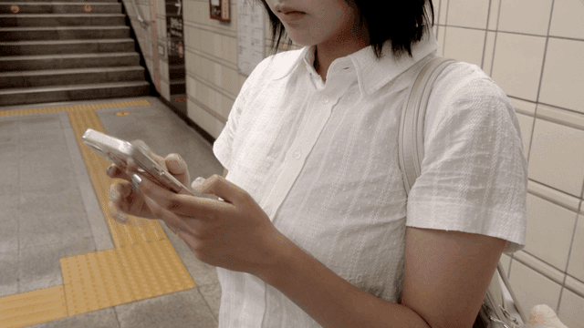 Woman using a smartphone in a subway station