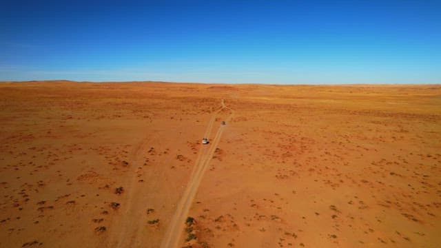 Vehicle Crossing the Vast Desert