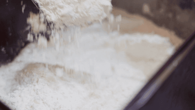 Sight of flour being poured into mixing bowl
