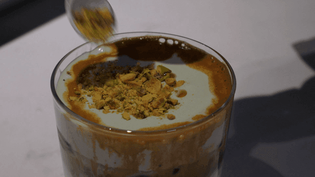 Latte topped with pistachios