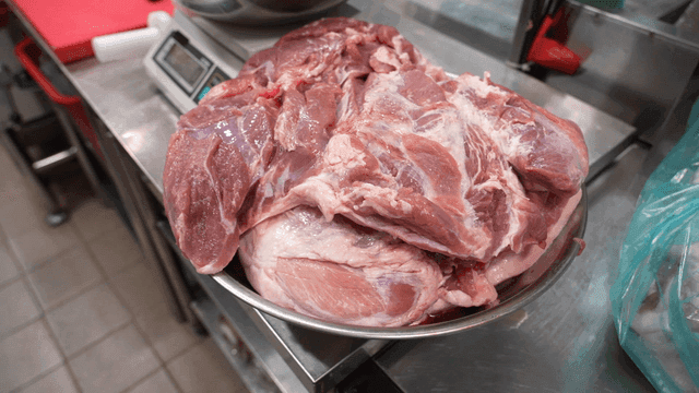 Whole raw meat in bowl beside kitchen scale