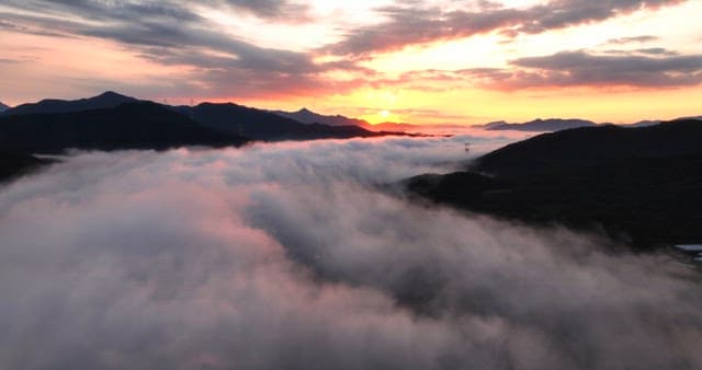 Sunrise over misty mountains