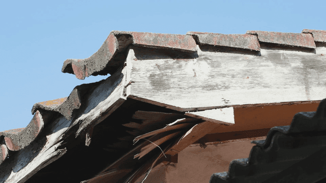 Old wooden roof under clear blue sky