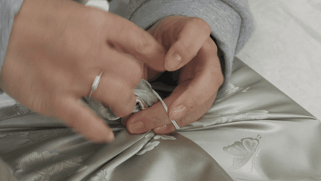 Hand wrapping gift with traditional cloth