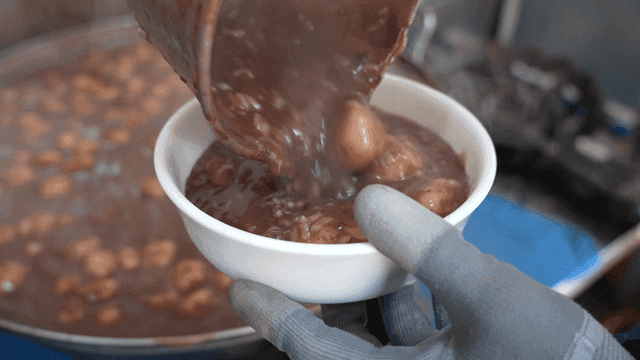 Red bean porridge being poured into bowl