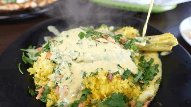 Smooth jamid sauce poured over Mansaf