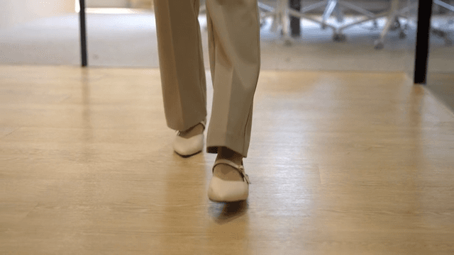 Legs of office worker walking in office