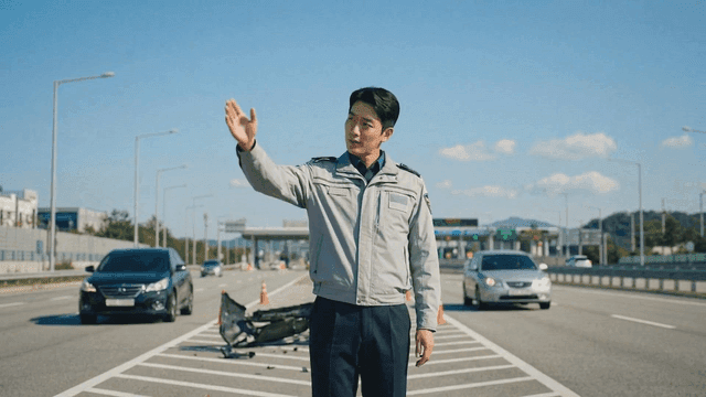 Traffic officer directing cars on highway