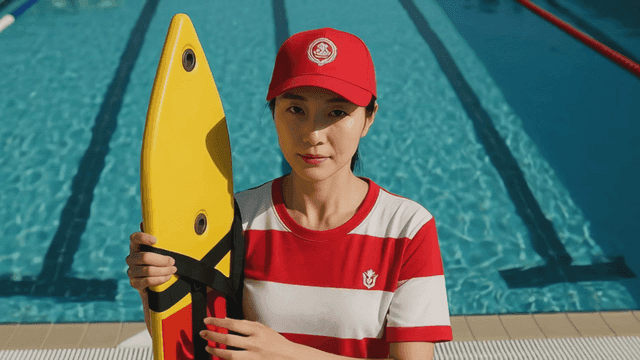 Lifeguard standing by the poolside