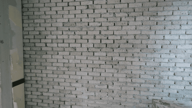 Brick wall under construction at construction site