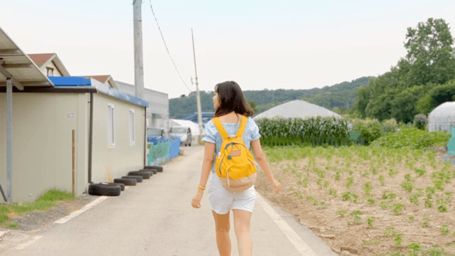 A young woman walking along a rural road