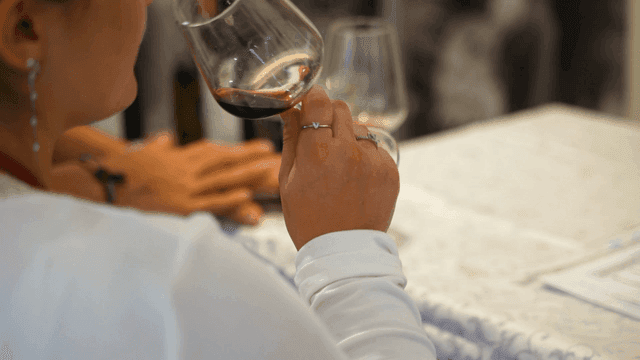 Profile of woman tasting red wine