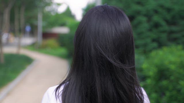 길을 걷다 위를 올려다보는 여성