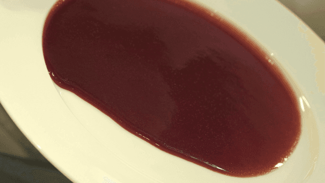 Thick red sauce spread on a white plate