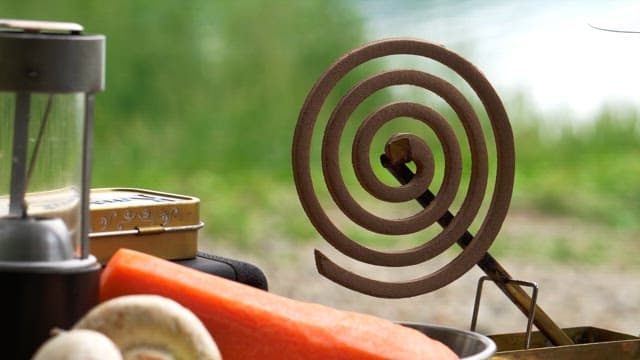 Lighting a mosquito coil on a sunny day outdoors