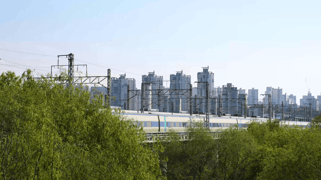 High-speed train passing through cityscape