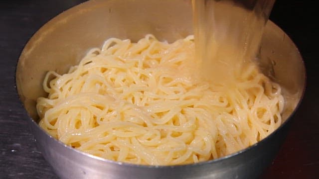 Noodles and cold udon broth prepared in a bowl