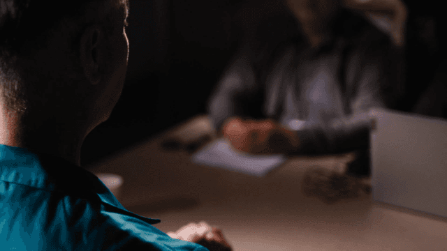 Back of prisoner being investigated by detectives