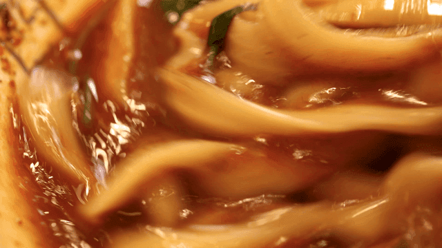 Spicy hand-cut noodles mixed with chopsticks