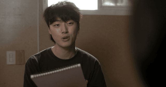 Young man talking with notebook in room