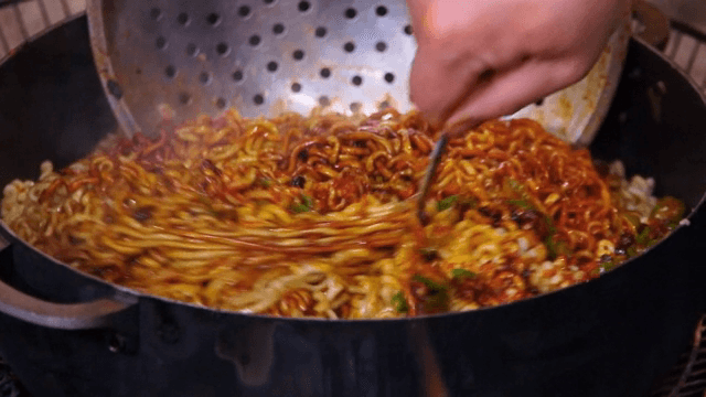Stir-frying noodles in a pan