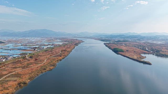 Serene river flowing through farmland