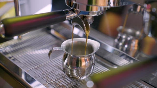 Fresh Espresso Dripping into a Steel Mug