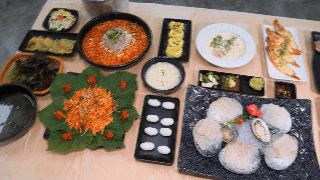 Table laden with various sashimi and side dishes