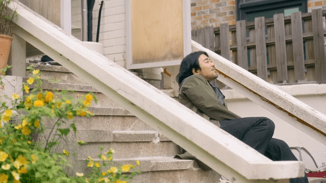 Man sitting and resting on the entrance steps