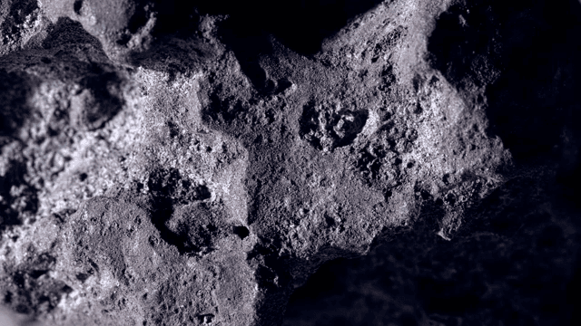 Surface of a dark rock illuminated by light