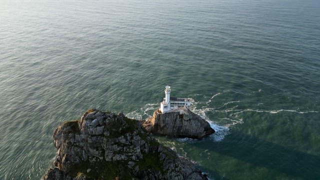 Lighthouse on a rocky island in the sea